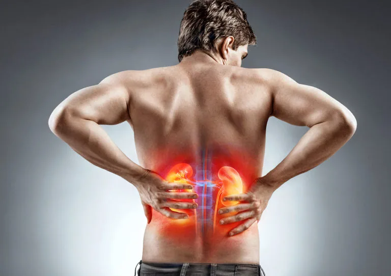 Man holding lower back with glowing red illustration of kidneys and spine overlay indicating pain or inflammation